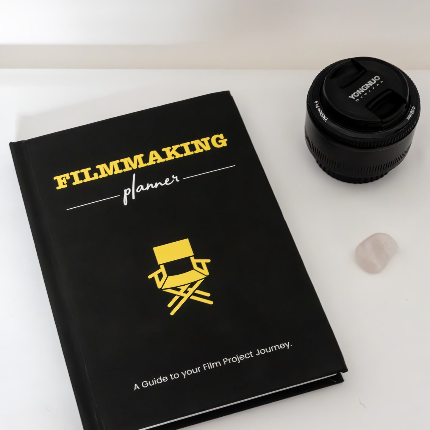 image of the filmmaking planner next to a camera lens