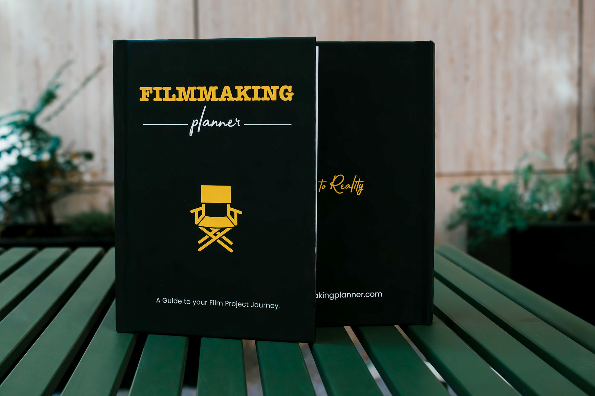 Black A5, Filmmaking Planner with yellow font and director chair symbol 