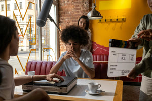 Filmmakers on location shooting a film in the cafe 