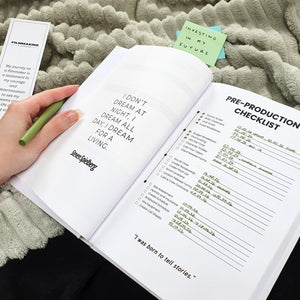 Open book with text and checklist on a textured surface