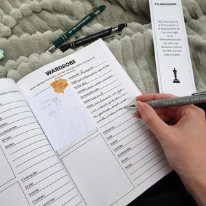 Person filling out a planner with notes on a textured surface
