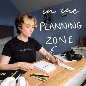 Person sitting at a desk with text 'in the PLANNING ZONE' above them.