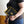 Person holding a black notebook with yellow text and graphics, wearing a black t-shirt with yellow text.