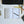 Open planner with task listings on a desk with a keyboard and pens.