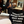 Person holding a black bag with text in a bathroom setting
