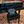 Piano with a cushion with text in a lobby setting