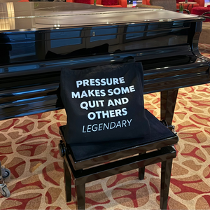 Piano with a cushion with text in a lobby setting
