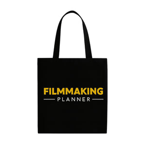 Black tote bag with 'Filmmaking Planner' text in yellow and white on a white background