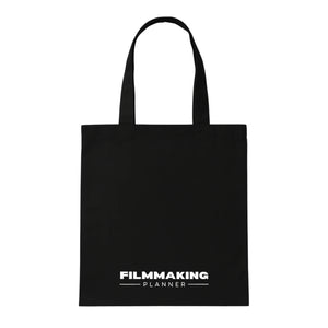 Black tote bag with 'Filmmaking Planner' text on a white background