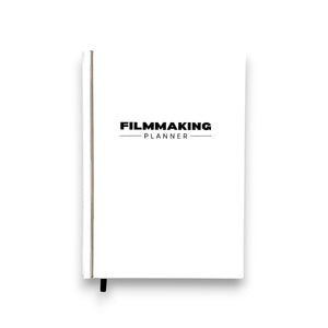 White notebook with 'Filmmaking Planner' text on a white background